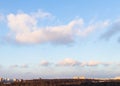 Fluffy clouds in blue sunset sky over city park Royalty Free Stock Photo