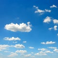 Fluffy clouds on bright blue sky Royalty Free Stock Photo