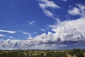 Fluffy clouds dance over the southwest landscape of north central New Mexico after a recent rain shower