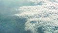 Fluffy clouds over earth ground. View from airplane Royalty Free Stock Photo