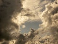 Fluffy clouds over sunset sky. Fluffy cumulus cloud shape photo, gloomy cloudscape background, smoke in the sky Royalty Free Stock Photo