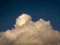 Fluffy clouds over sunset sky. Fluffy cumulus cloud shape photo, gloomy cloudscape background, smoke in the sky Royalty Free Stock Photo