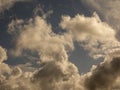 Fluffy clouds over sunset sky. Fluffy cumulus cloud shape photo, gloomy cloudscape background, smoke in the sky Royalty Free Stock Photo
