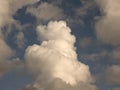 Fluffy clouds over sunset sky. Fluffy cumulus cloud shape photo, gloomy cloudscape background, smoke in the sky Royalty Free Stock Photo