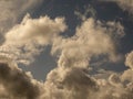 Fluffy clouds over sunset sky. Fluffy cumulus cloud shape photo, gloomy cloudscape background, smoke in the sky Royalty Free Stock Photo