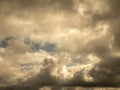 Fluffy clouds over sunset sky. Fluffy cumulus cloud shape photo, gloomy cloudscape background, smoke in the sky Royalty Free Stock Photo
