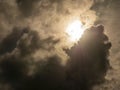 Fluffy clouds over sunset sky and sun rays. Fluffy cumulus cloud shape photo, gloomy cloudscape background, smoke in the sky Royalty Free Stock Photo