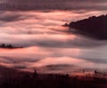 Fluffy clouds seen from above with the mountains peaking through