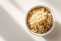 Fluffy cooked quinoa served in a white ceramic bowl on white background Ai photo Royalty Free Stock Photo
