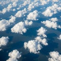 Clouds are white, with varying densities and sizes, creating a Royalty Free Stock Photo