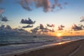 Fluffy dark clouds floating over turbulent ocean waters on sandy beach shore Royalty Free Stock Photo