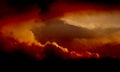 Fluffy dramatic clouds like fire in the sky with golden clouds