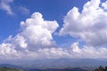 Huge dramatic white cloud on blue sky over green mountain Royalty Free Stock Photo