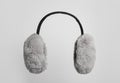 Fluffy earmuffs on white background. Stylish winter accessory