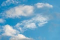 fluffy gentle clouds slowly and hopelessly float across the endless sea of blue sky. Clear blue sky after the raging elements and Royalty Free Stock Photo