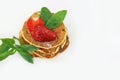 Fluffy golden pancakes with strawberries and syrup on white background with copy space Royalty Free Stock Photo