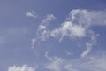 The fluffy, heart shaped clouds in the blue sky are a sign of love in the beautiful Royalty Free Stock Photo