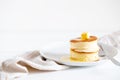 Fluffy Japan souffle pancakes, hotcakes with butter and maple syrup or honey sauces on light white background Royalty Free Stock Photo