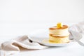 Fluffy Japan souffle pancakes, hotcakes with butter and maple syrup or honey sauces on light white background