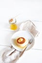 Fluffy Japan souffle pancakes, hotcakes with butter and maple syrup or honey sauces on light white background