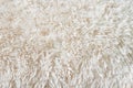 Fluffy long pile soft woolen light beige carpet above view macro