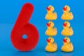 Fluffy number 6 with six rubber ducks, 3D rendering