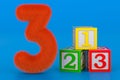 Fluffy number 3 with three abc cubes, 3D rendering Royalty Free Stock Photo