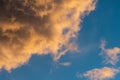 Fluffy orange clouds illuminated by the light coming from the setting sun. Pure nature untouched by man. Climate change from human Royalty Free Stock Photo