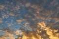 Fluffy orange clouds illuminated by the light coming from the setting sun. Pure nature untouched by man. Climate change from human Royalty Free Stock Photo