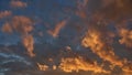 Fluffy orange clouds illuminated by the light coming from the setting sun. Pure nature untouched by man. Climate change from human Royalty Free Stock Photo