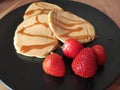 Fluffy pancakes with toffee topping and fresh strawberries Royalty Free Stock Photo