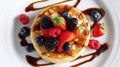 Fluffy pancakes topped with mixed berries and syrup Royalty Free Stock Photo