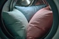 Fluffy pillows spinning in washing machine for deep clean Royalty Free Stock Photo