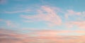 Fluffy pink cirrus clouds at light blue sky, beautiful sunset scenery Royalty Free Stock Photo