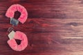 Fluffy pink handcuffs on a dark wooden table Royalty Free Stock Photo