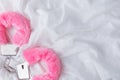 Fluffy pink handcuffs on white fabric background Royalty Free Stock Photo