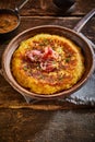 Fluffy potato egg pancake cooking in rustic pan Royalty Free Stock Photo