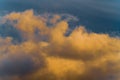 Fluffy thunderstorm clouds illuminated by disappearing rays at sunset, thunderclouds floating across sunny blue sky to change Royalty Free Stock Photo