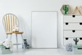 Fluffy toy placed on wooden chair in white baby room interior wi