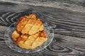 Fluffy waffles. They lie on a saucer. Background from black pine boards. Shot close-up Royalty Free Stock Photo