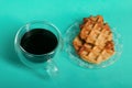 Fluffy waffles. They lie on a saucer. Next to a cup of coffee. Light green background. Shot close-up Royalty Free Stock Photo