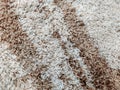 Fluffy and warm wool carpet in brown and beige color with soft texture and interesting abstract pattern for interior decoration