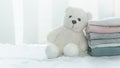 Fluffy white bear doll with soft comfortable pink grey blue fabric cloth stack white cozy home interior web design banner Royalty Free Stock Photo