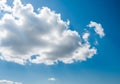 Fluffy white cloud against a bright blue sky Royalty Free Stock Photo