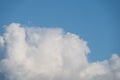 Fluffy white cloud close-up with blue sky