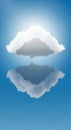 A fluffy white cloud floats against a bright blue sky. Below, its reflection creates a Royalty Free Stock Photo