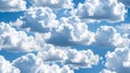 Fluffy white clouds against a bright blue sky, creating a seamless background. Royalty Free Stock Photo