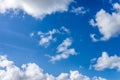 Fluffy white clouds against a bright, colorful blue sky Royalty Free Stock Photo