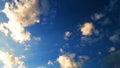 Fluffy white clouds on a blue gradient sky