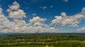 Fluffy white clouds in the blue sky over the green jungle. Royalty Free Stock Photo